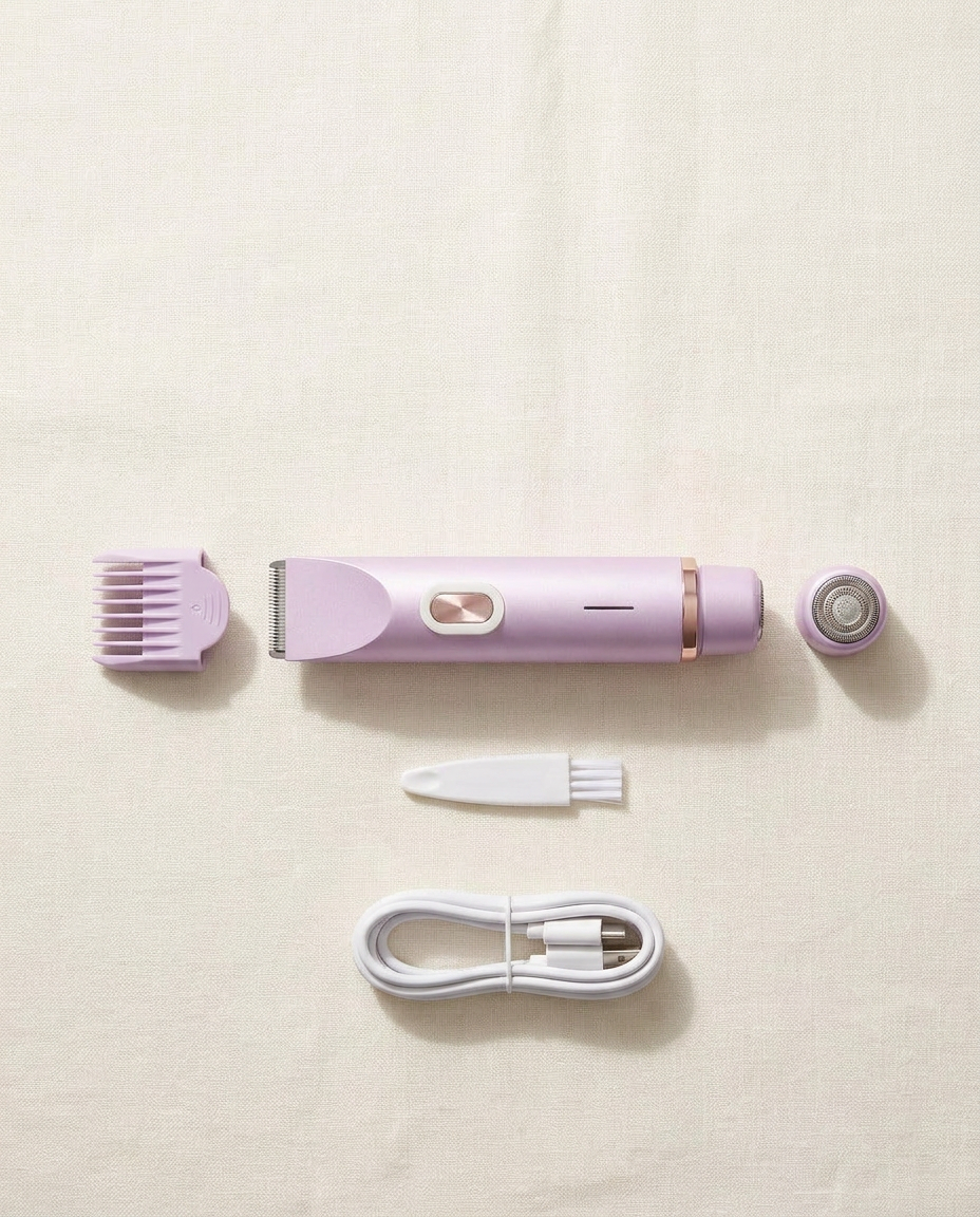 Flat-lay of everything in the box: the trimmer, adjustable comb guard, round foil head, cleaning brush and USB-C charging cable